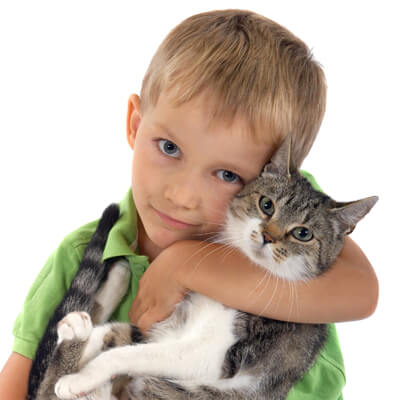 Child hugging cat